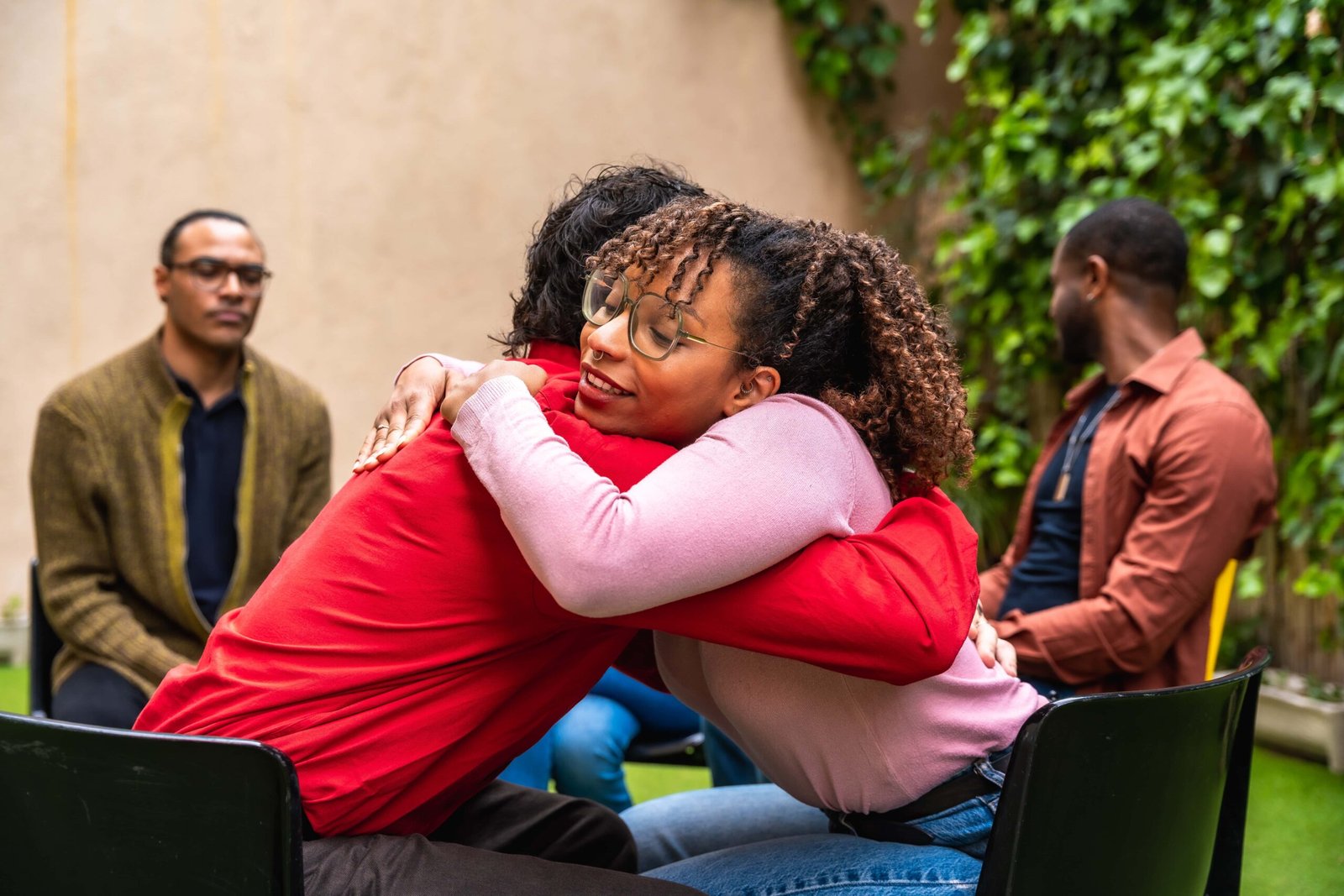 young-woman-hugging-person-during-group-gathering-2026-07-09-21-13-38-utc (1)